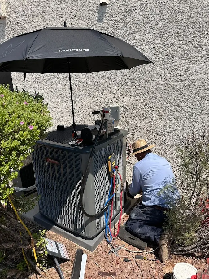HVAC technician performing outdoor AC maintenance in Springfield